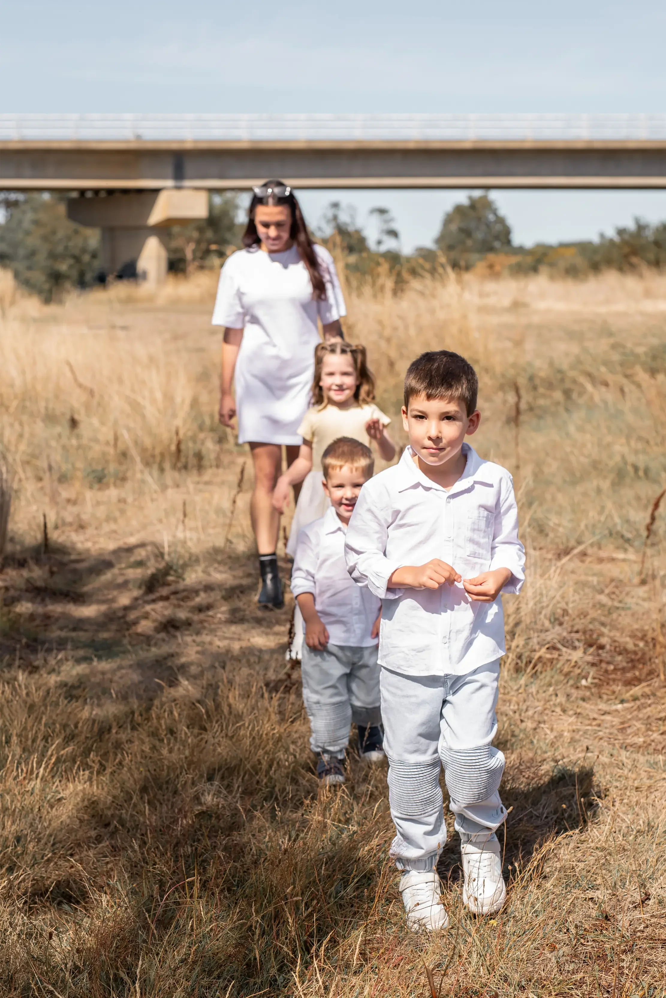 Family Walking Through Grassland